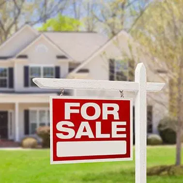 for sale sign in front yard